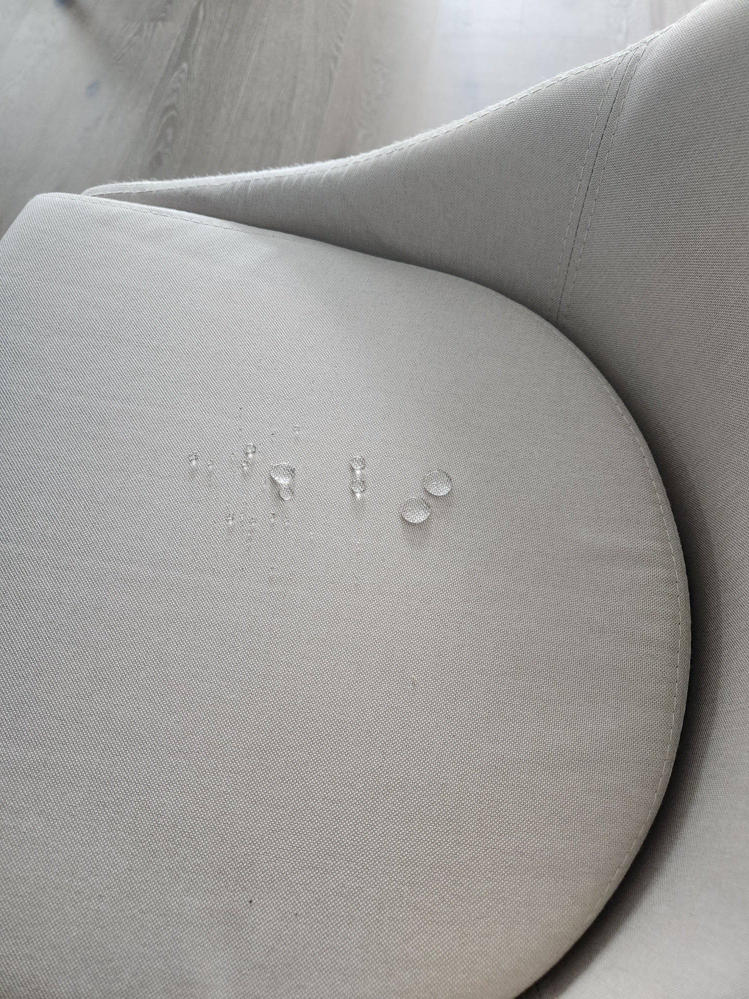 droplets on grey chair after applying protectMe fabric protector