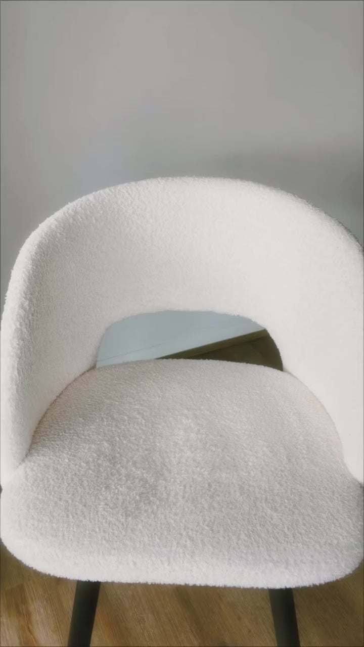 Lady using protectME a non-toxic fabric protector with its battery sprayer to evenly apply protectME on the white furniture and show spill protection