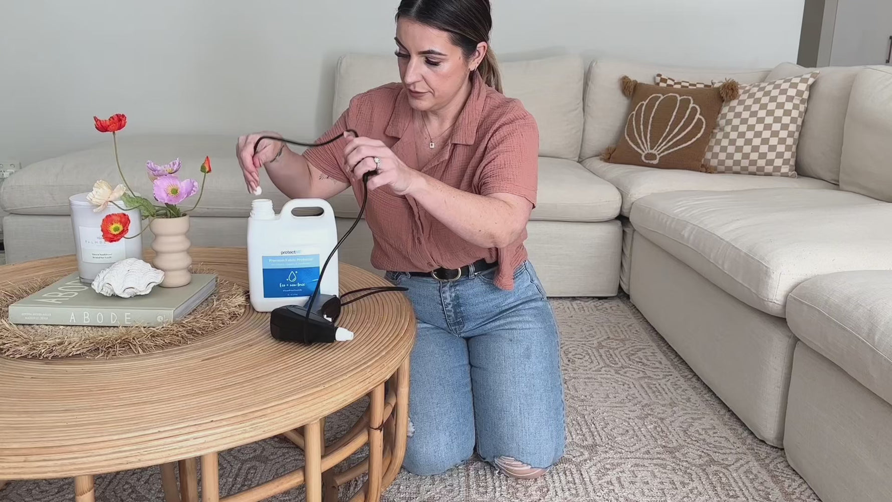 woman using protectMe big job bottle in her living room