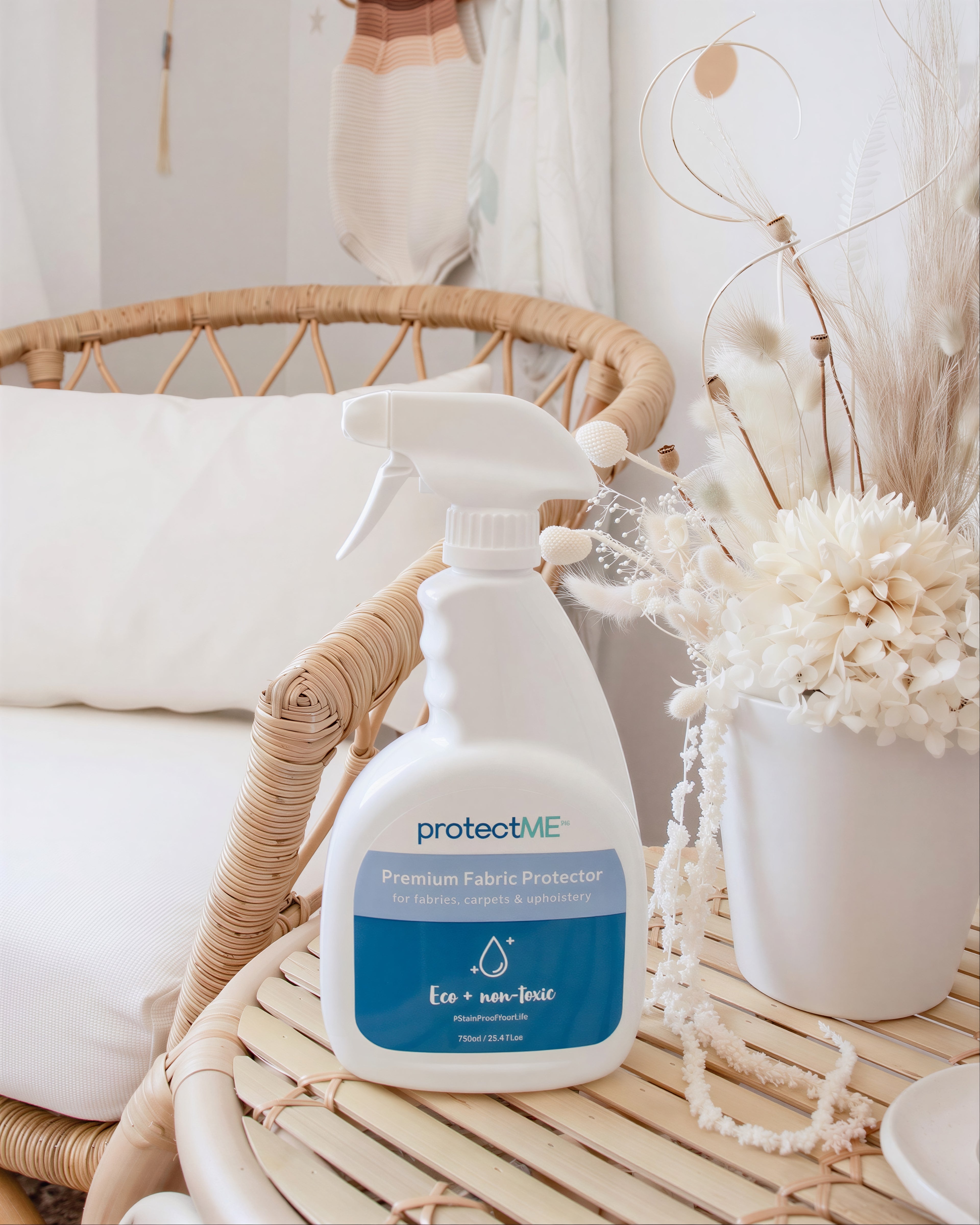 Spray bottle labeled 'protectME' on a woven surface with decorative elements in the background