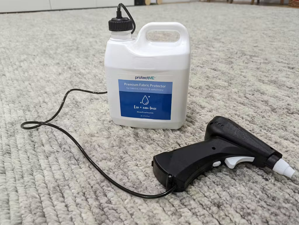Fabric protector bottle protectme with a spray gun on a carpet