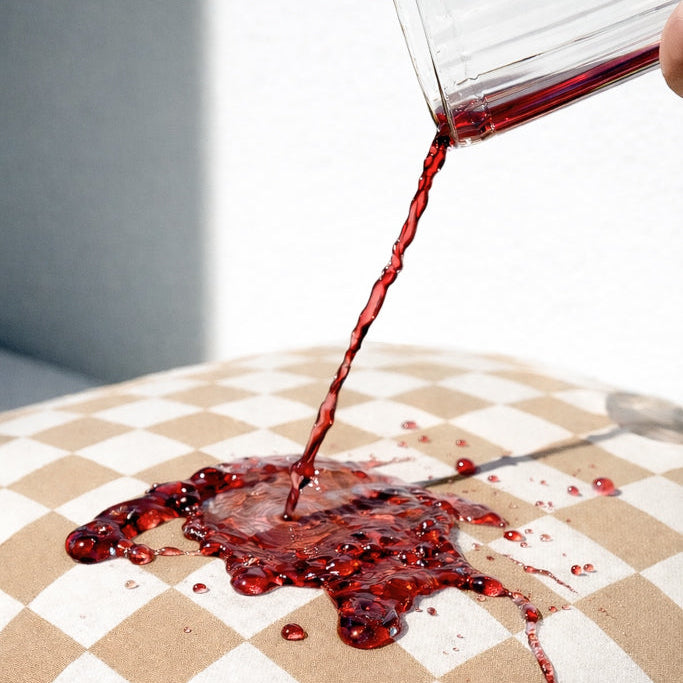 Red liquid being poured onto a checkered cushion